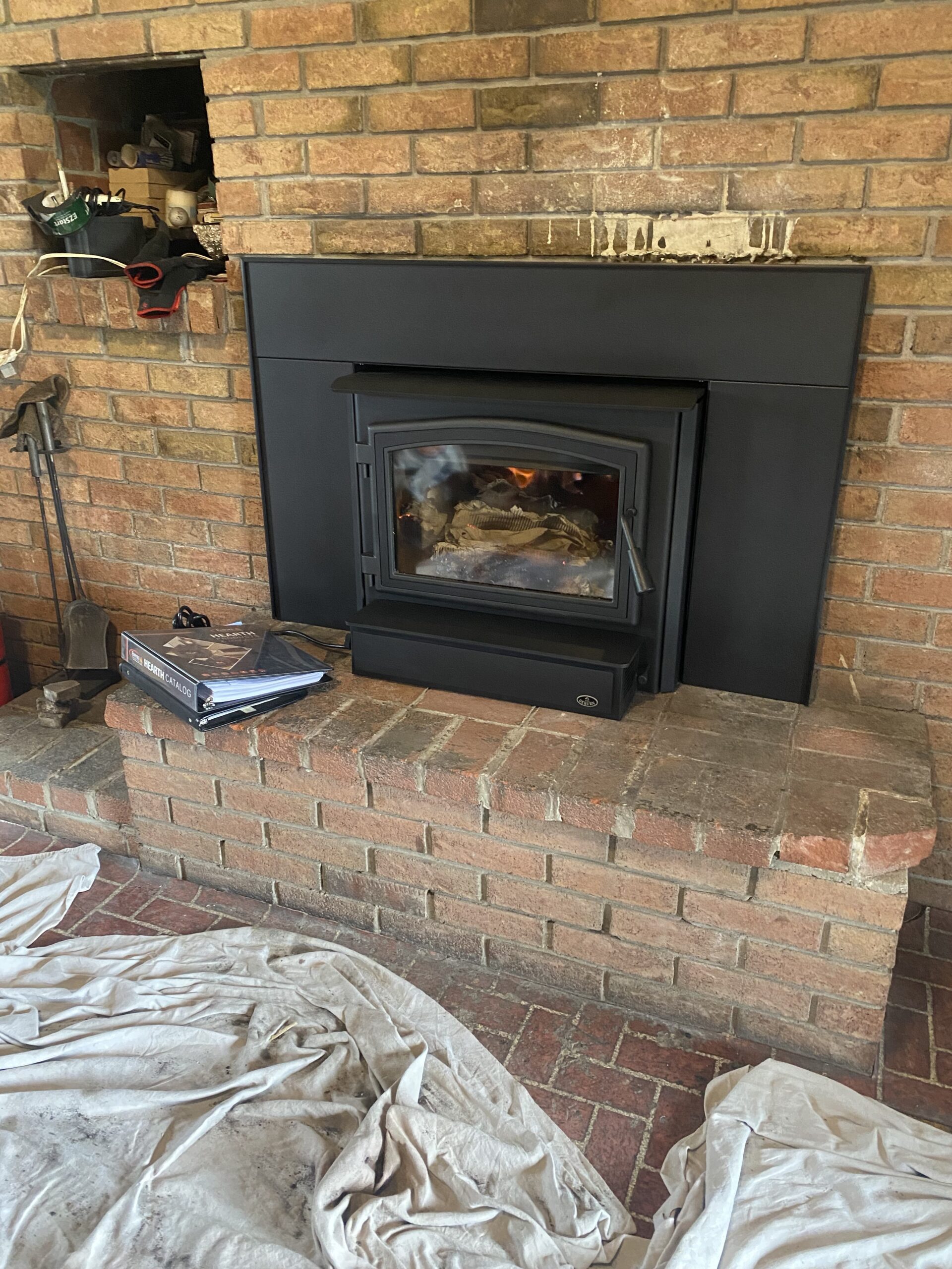 wood-burning fireplace insert being maintained